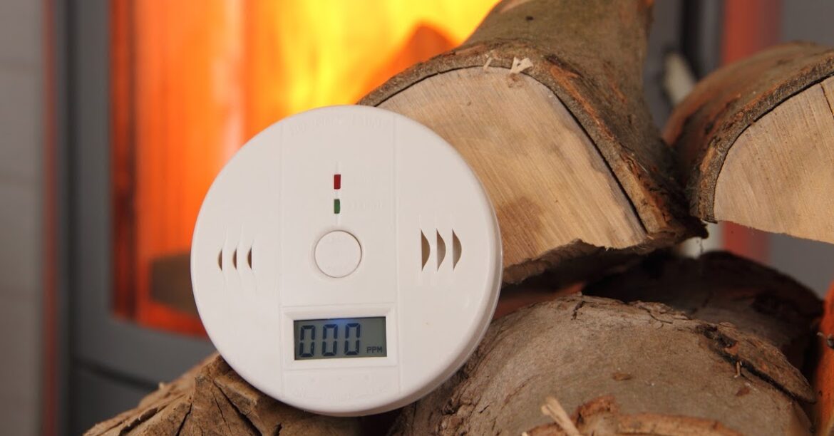 A carbon monoxyde detector on a wood pile
